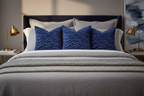 Three Midnight Tides Pillows on Gray Bed